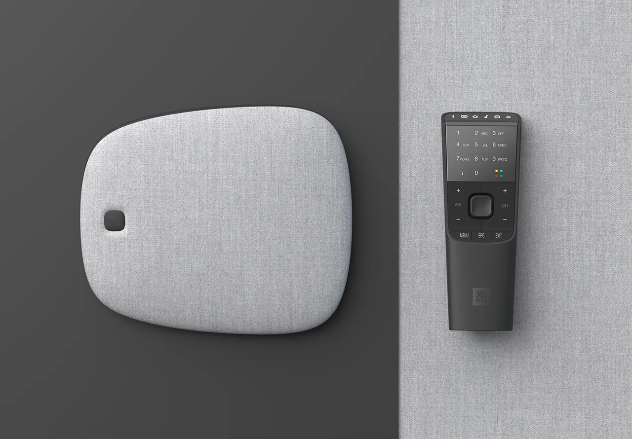 Xumo fabric covered set top box and controller sitting next to each other