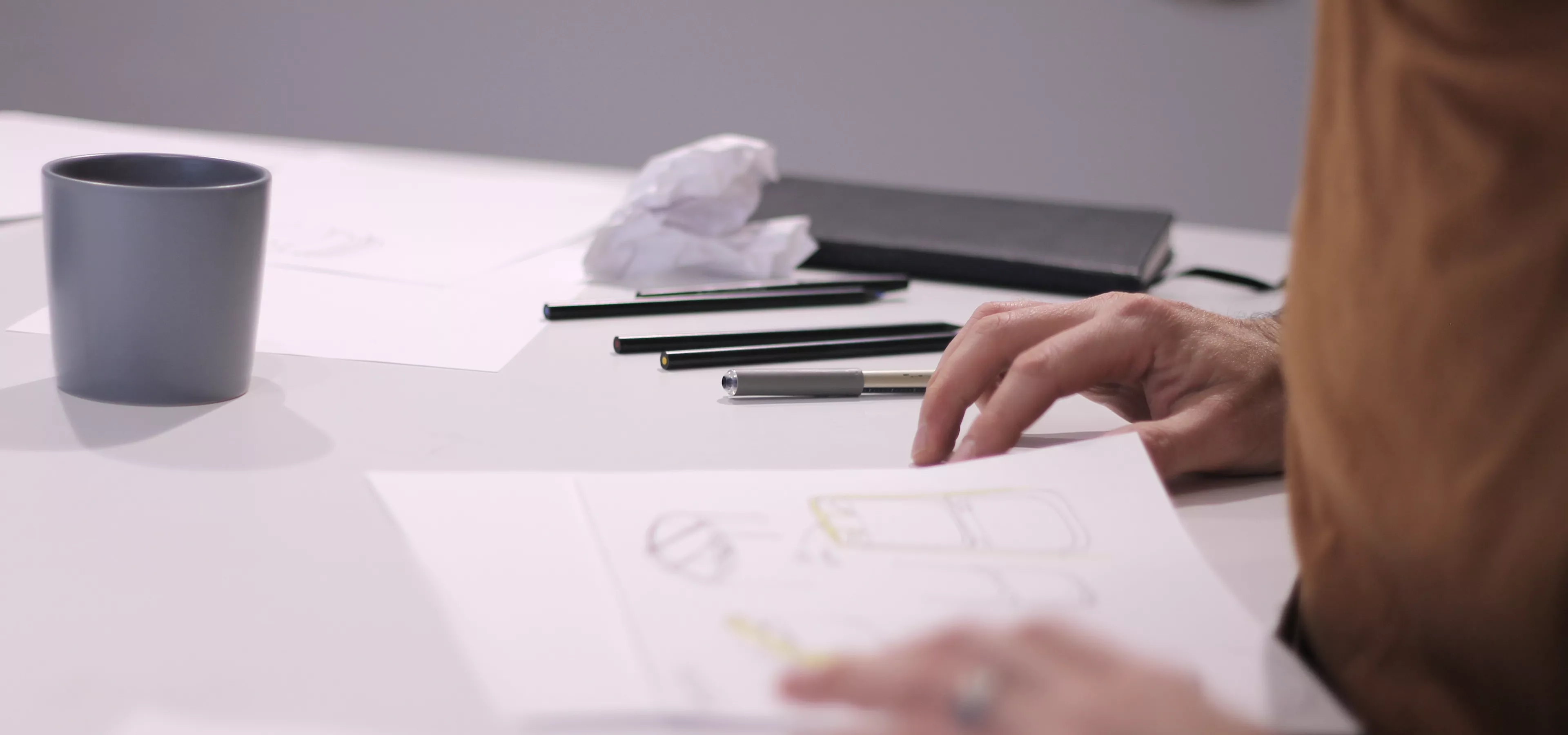 designer drawing at a table