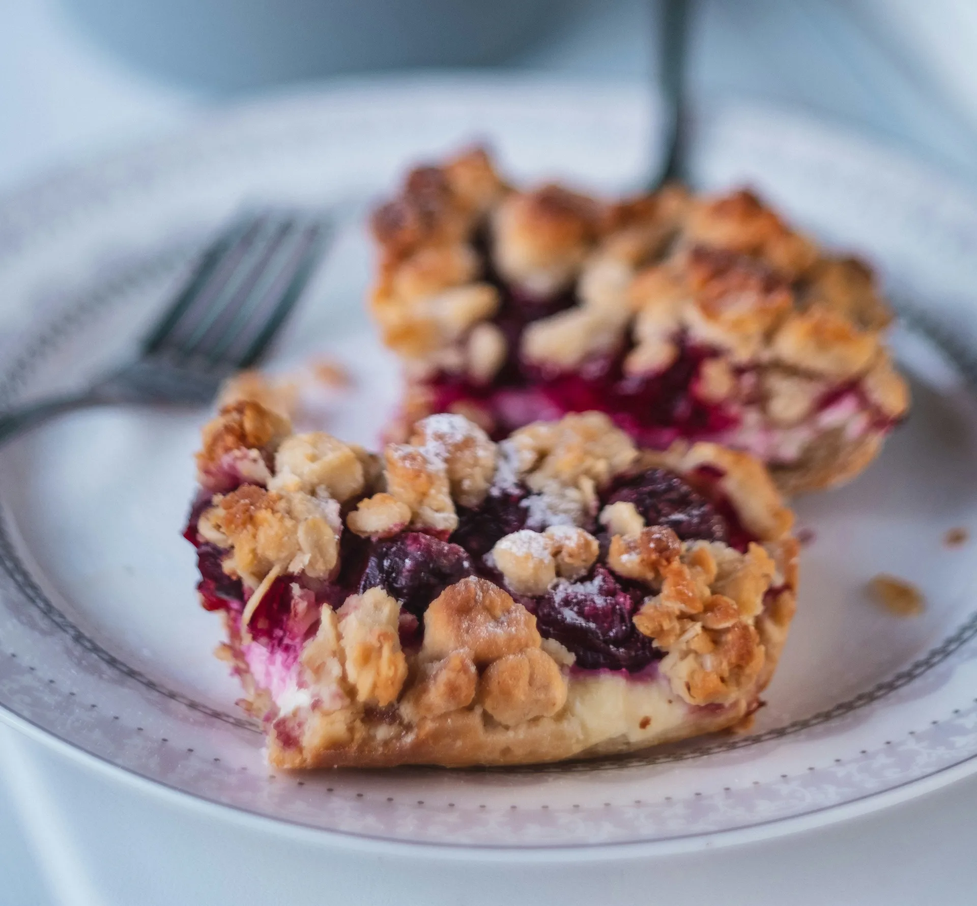 Freshly baked cherry bakewell tart on a plate