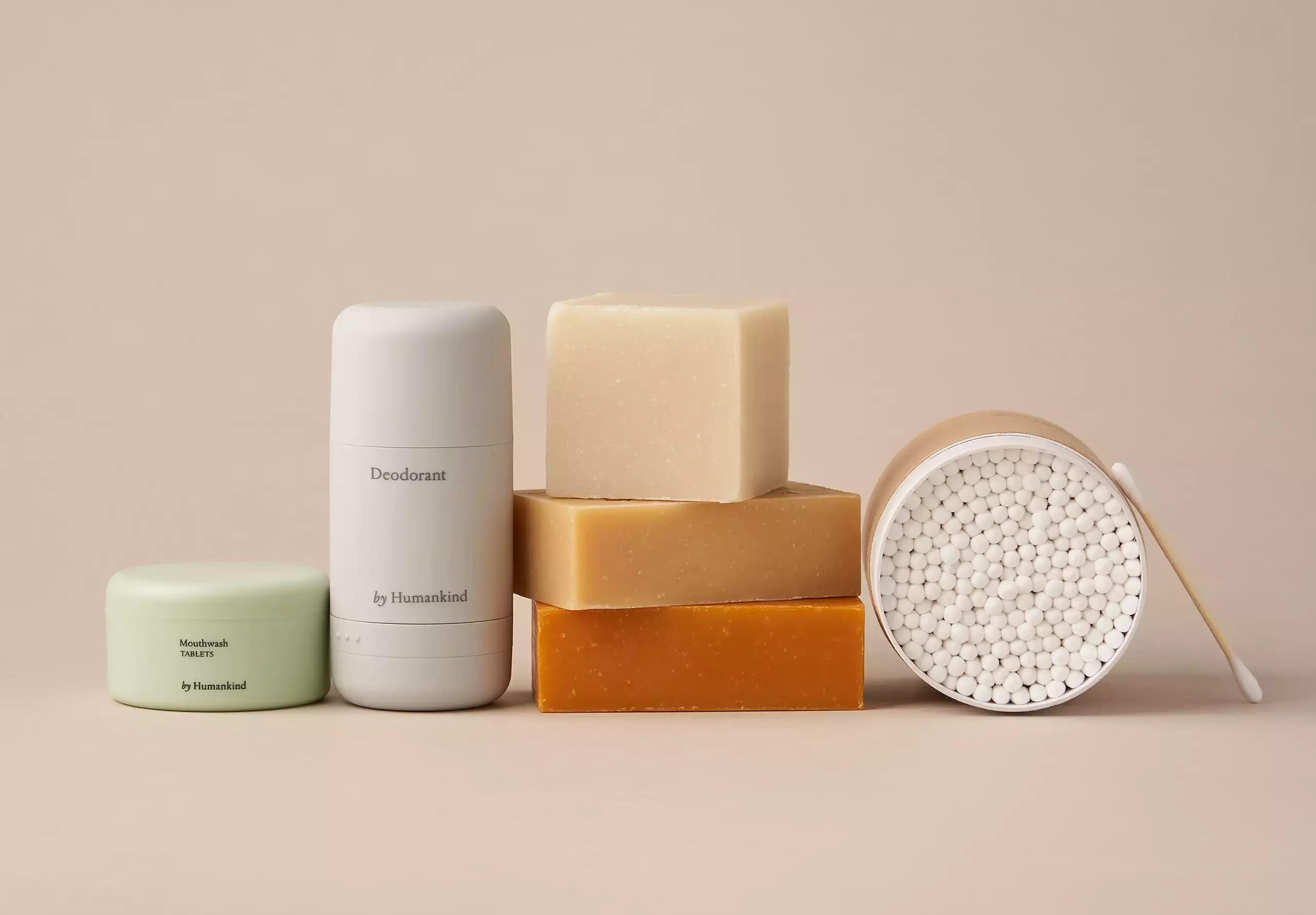 A lineup of beautiful byhumankind packaging in a pinky beige scene