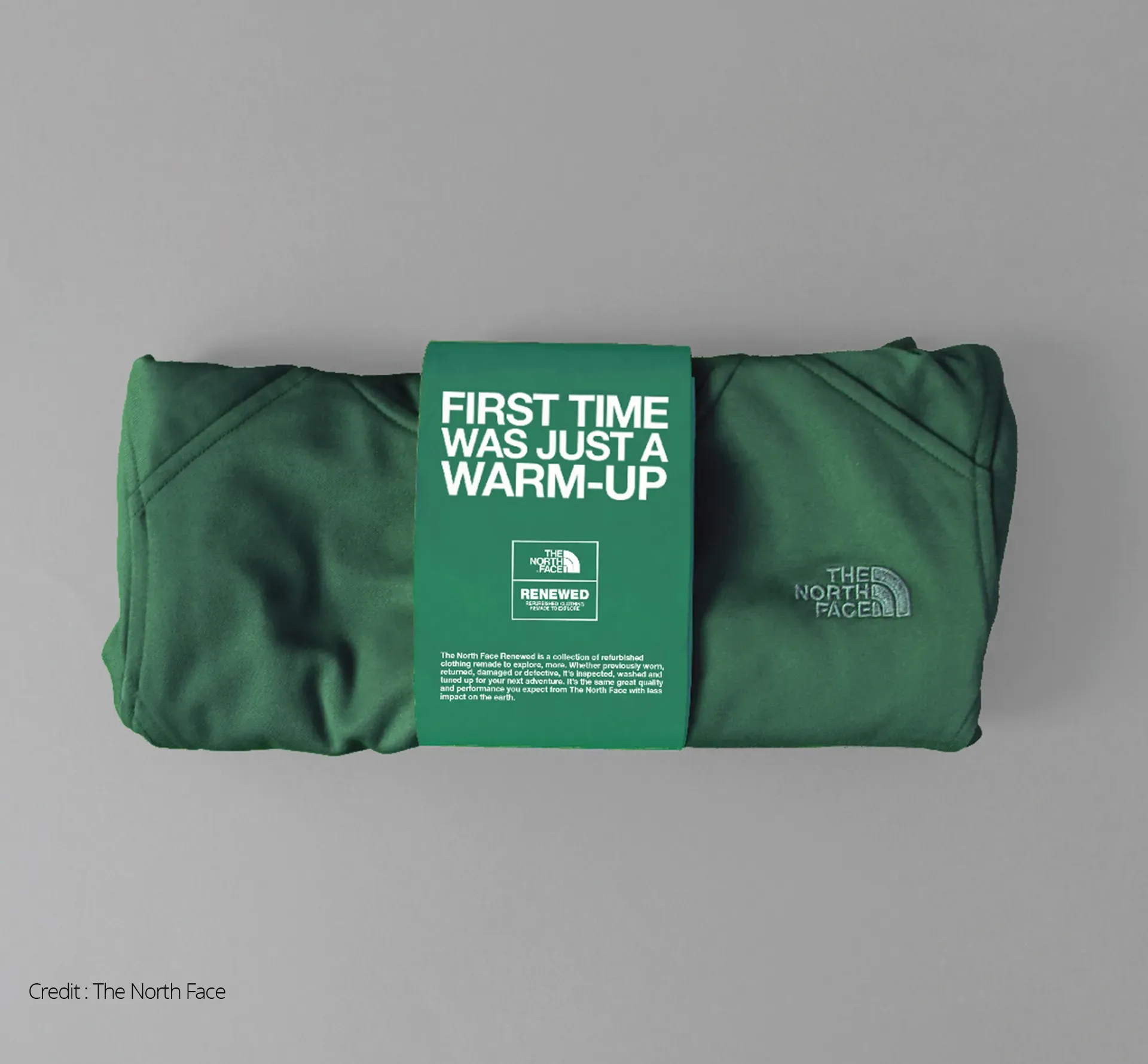 Green 'renewed' Northface jumper in packaging