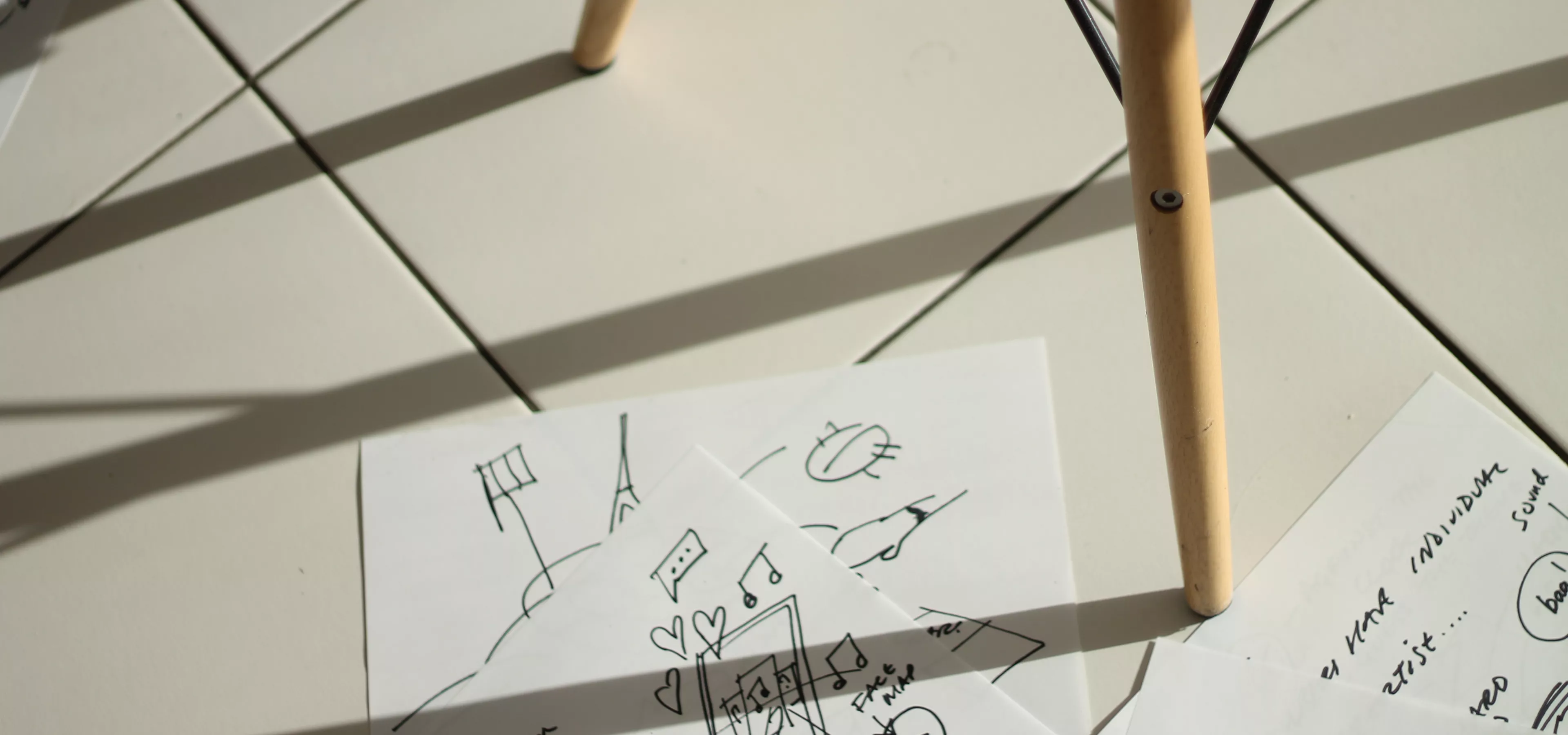 Design sketches on the floor by an Eames Chair