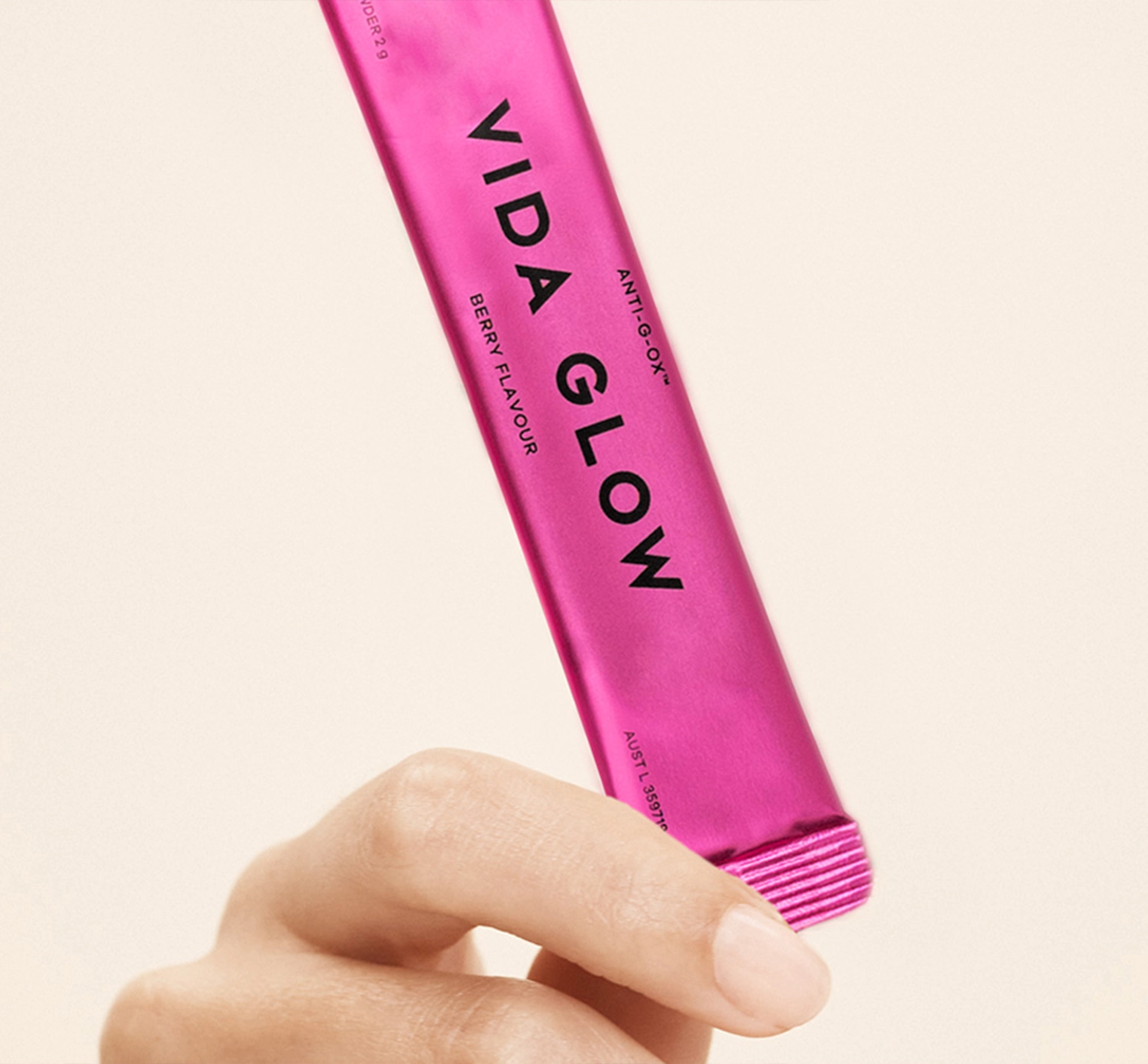 pink sachet being held in a hand