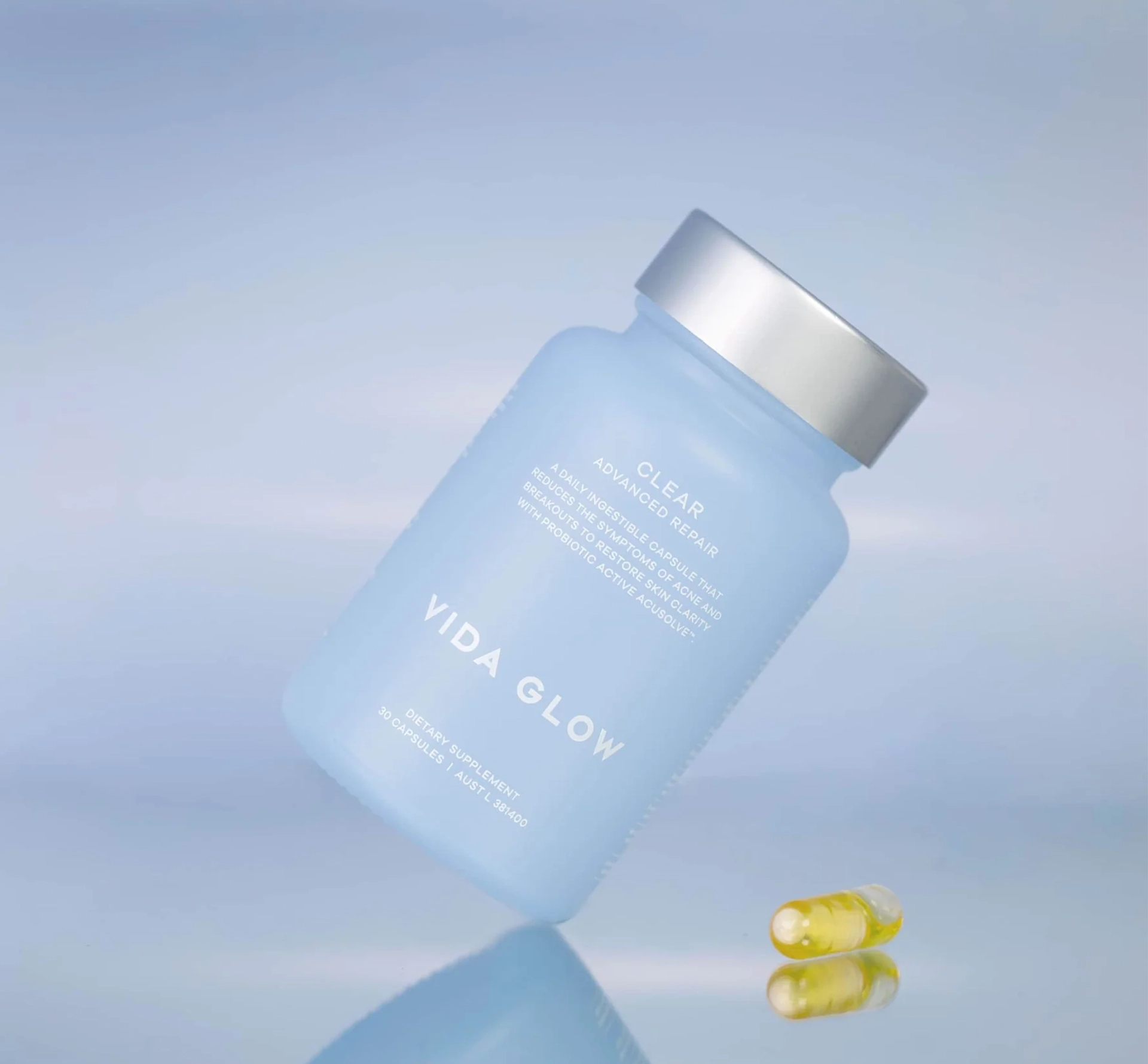 Vida glow clear bottle at an angle on blue background
