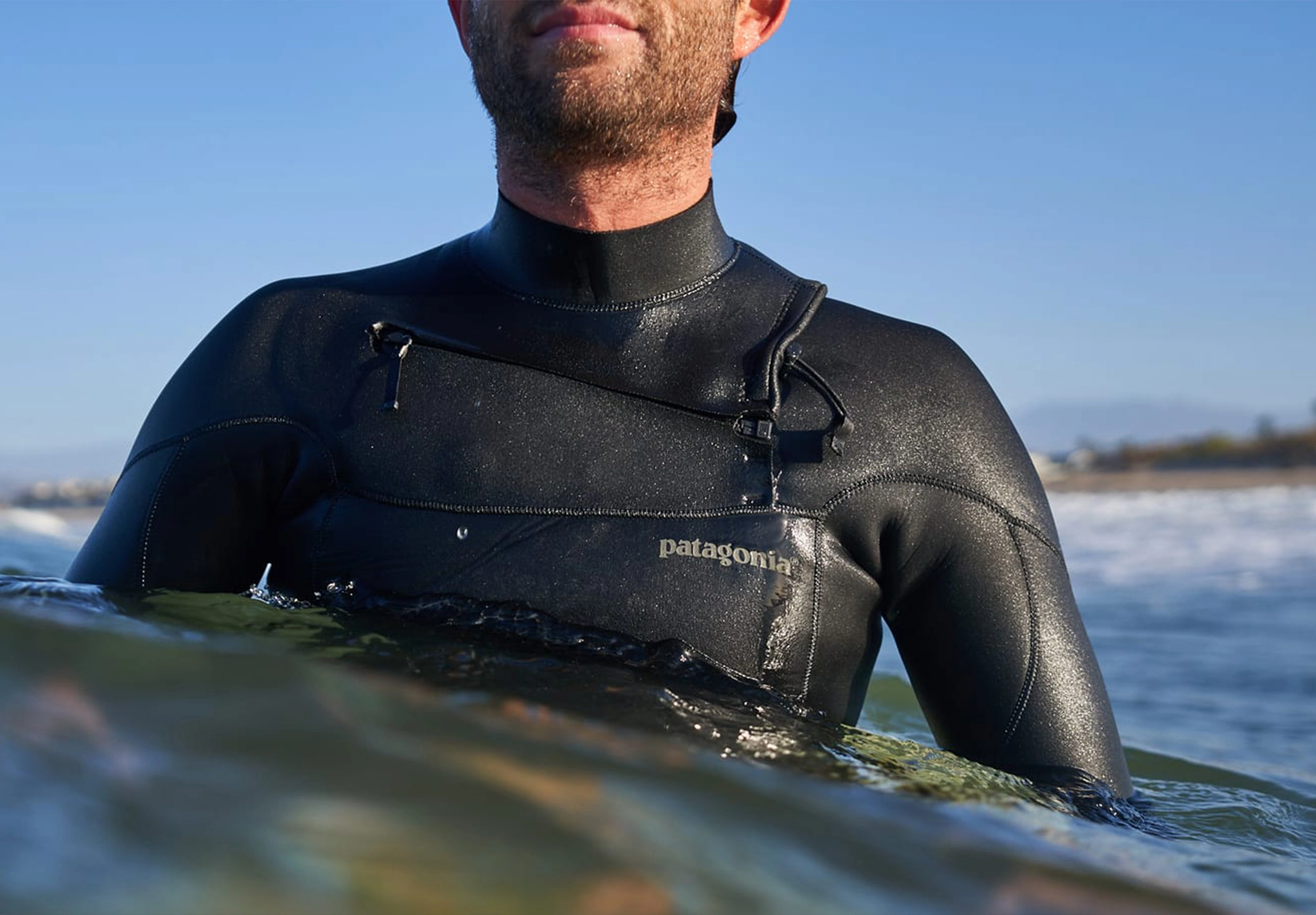 Man in sea wearing Patagonia wetsuit