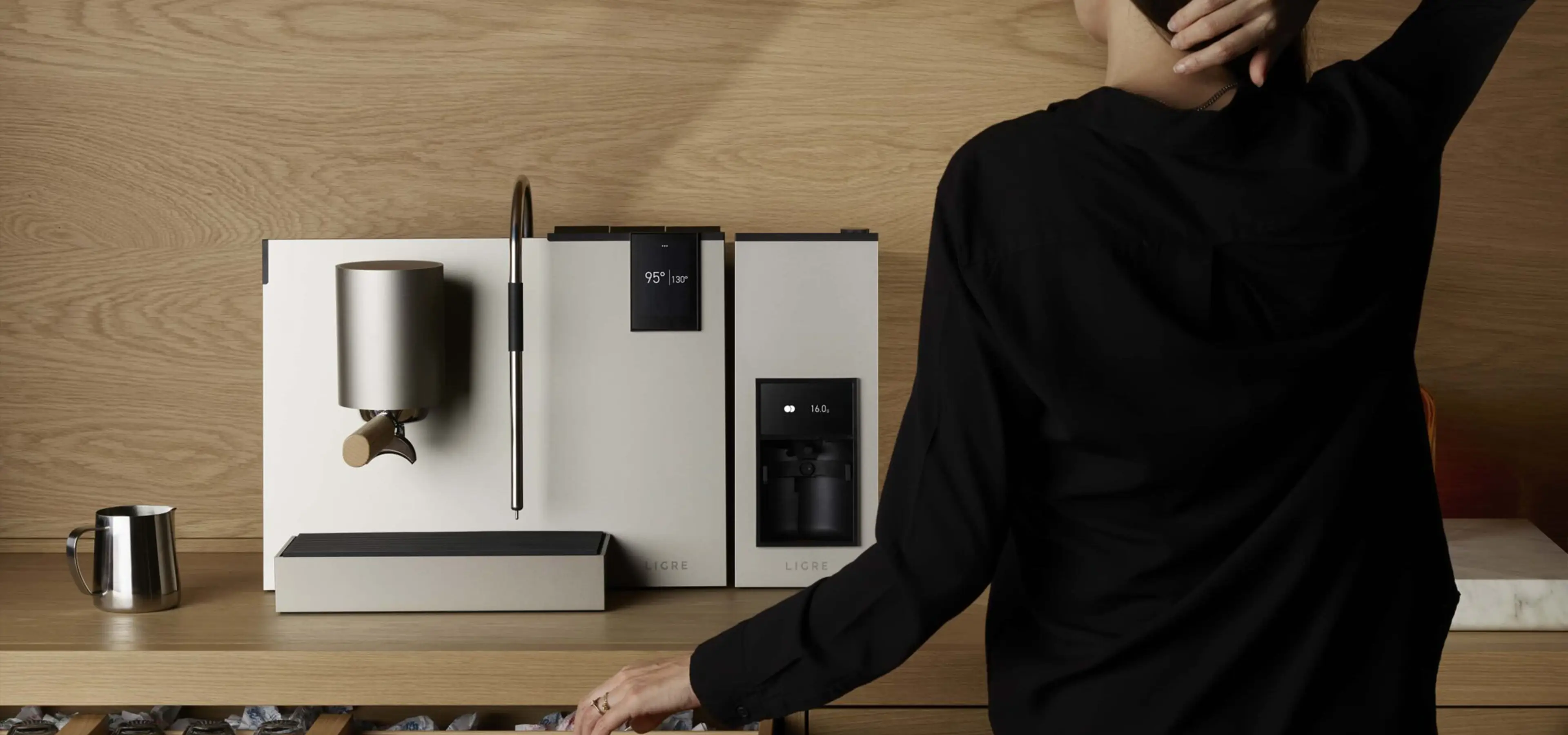 woman opening a drawer with coffee machine on the worktop