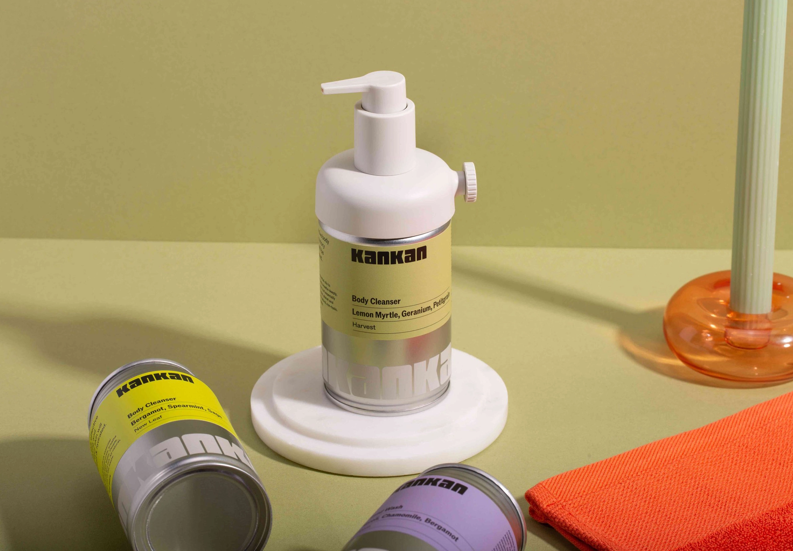 Body soap dispenser made out of a used aluminium can on green background