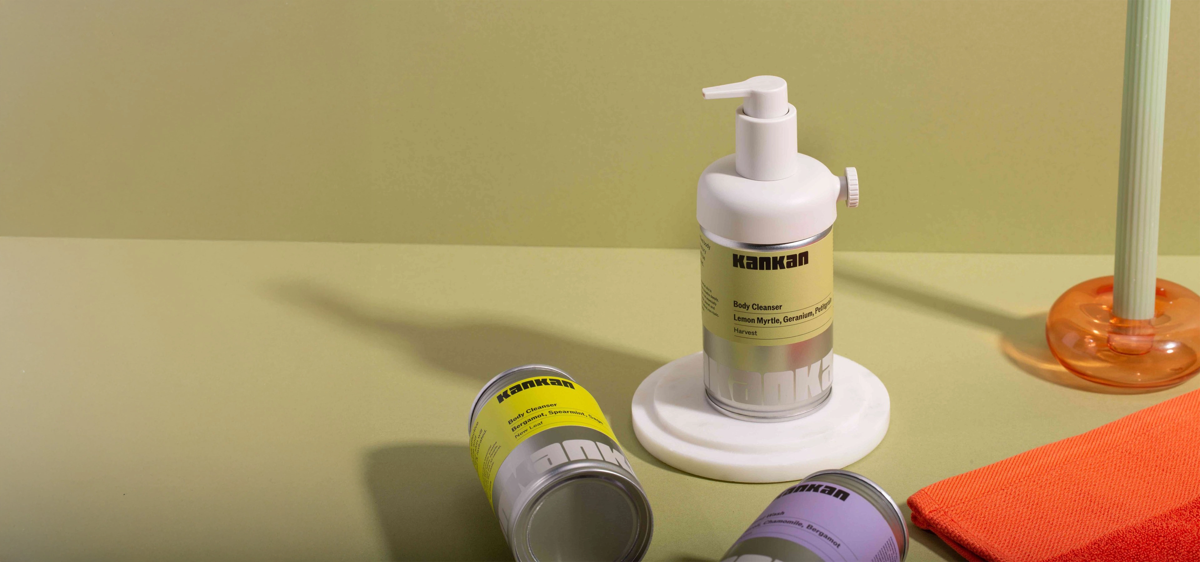 Body soap dispenser made out of a used aluminium can on green background