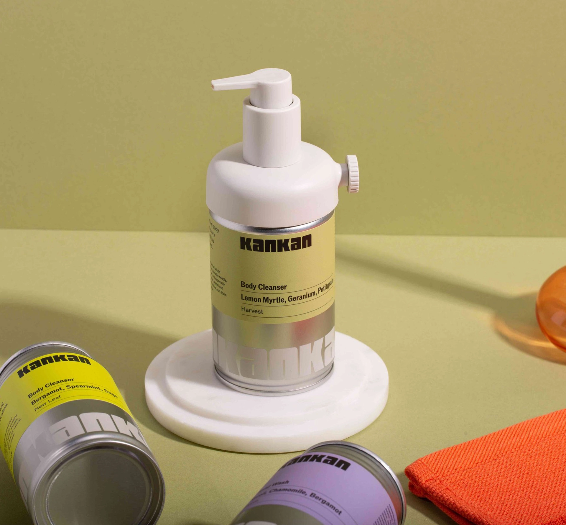 Body soap dispenser made out of a used aluminium can on green background