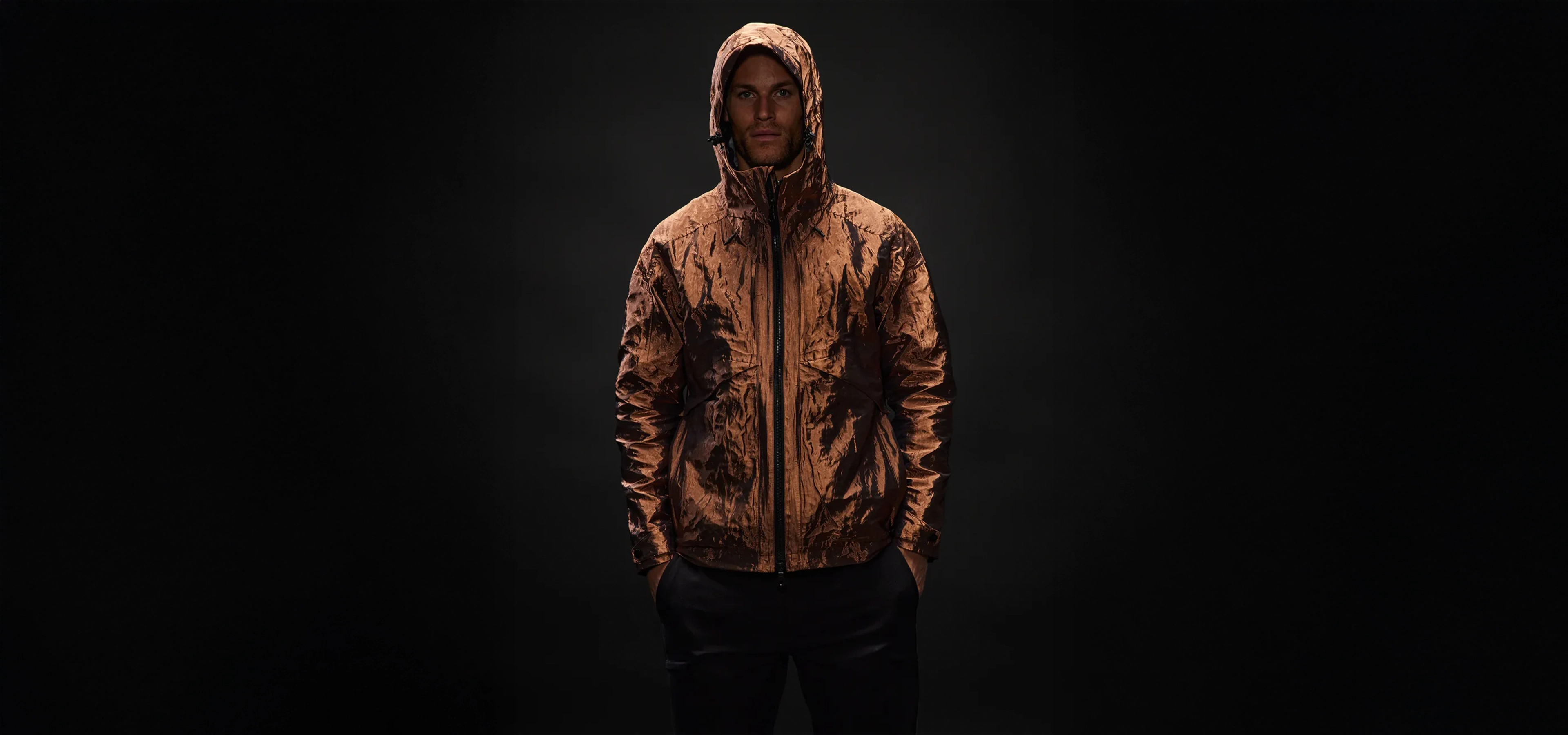 Man in a hooded copper coloured jacket