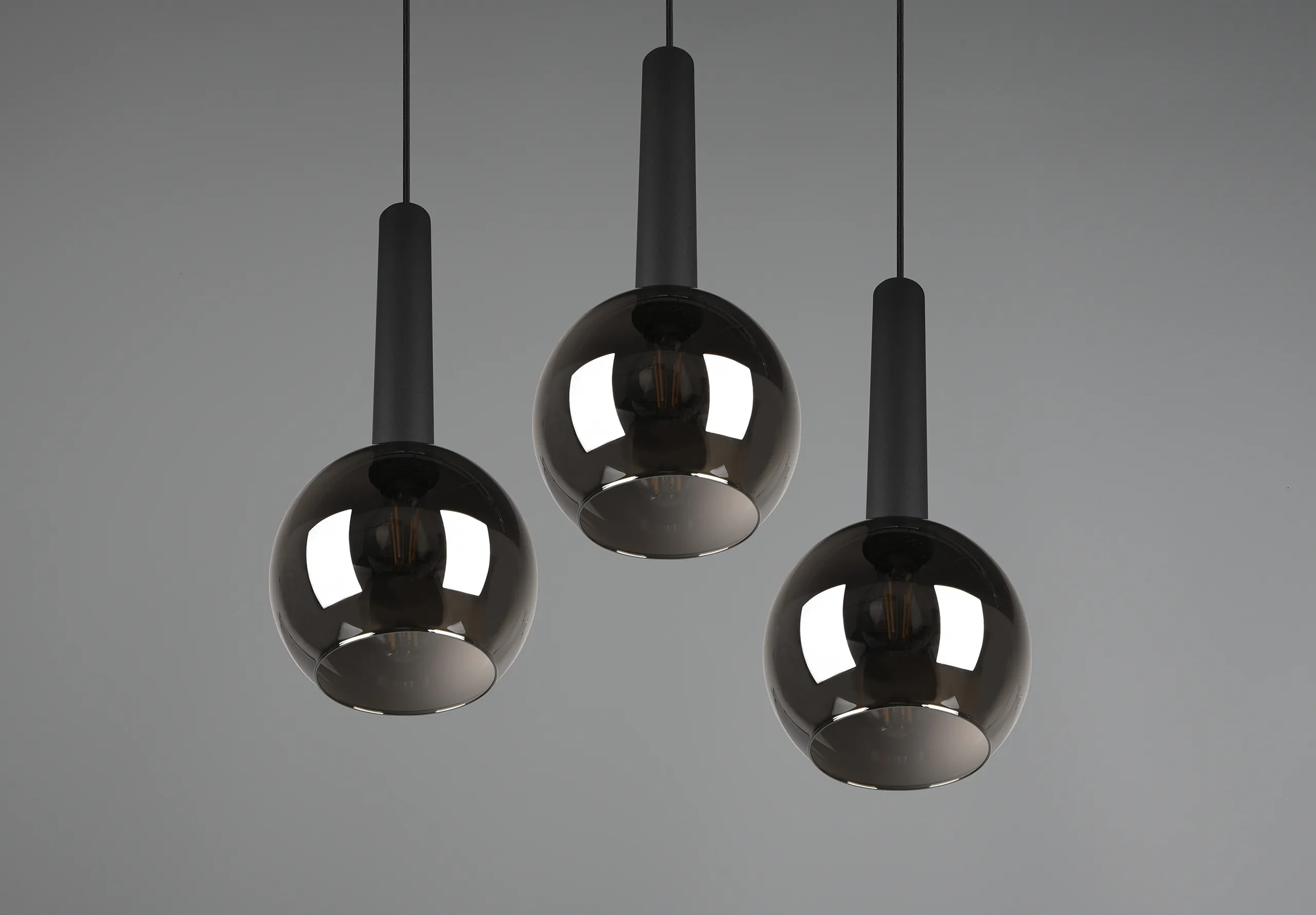 Three mirrored lamps hanging from the ceiling