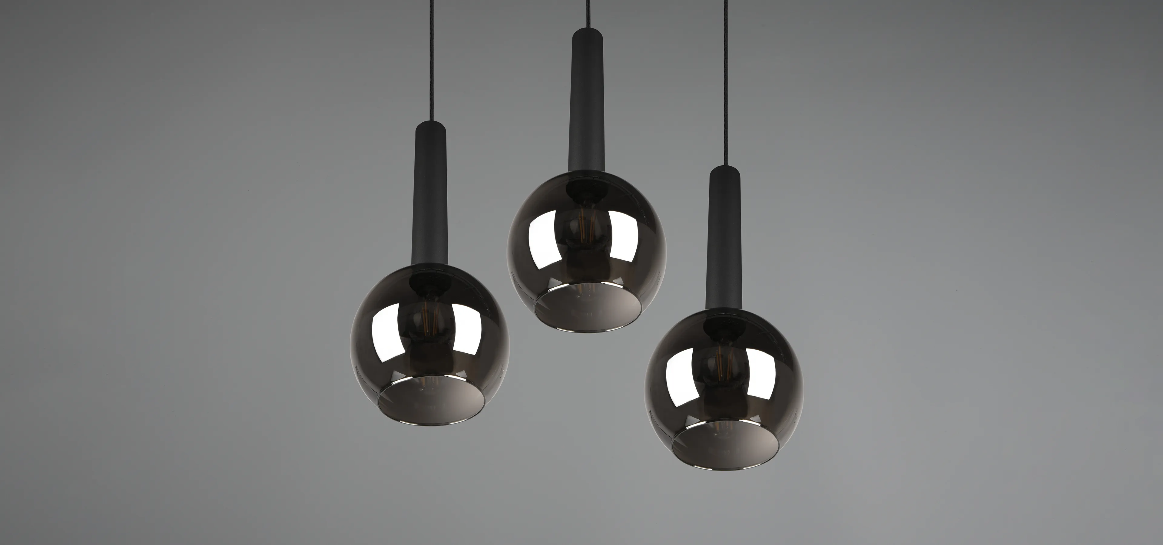 Three mirrored lamps hanging from the ceiling
