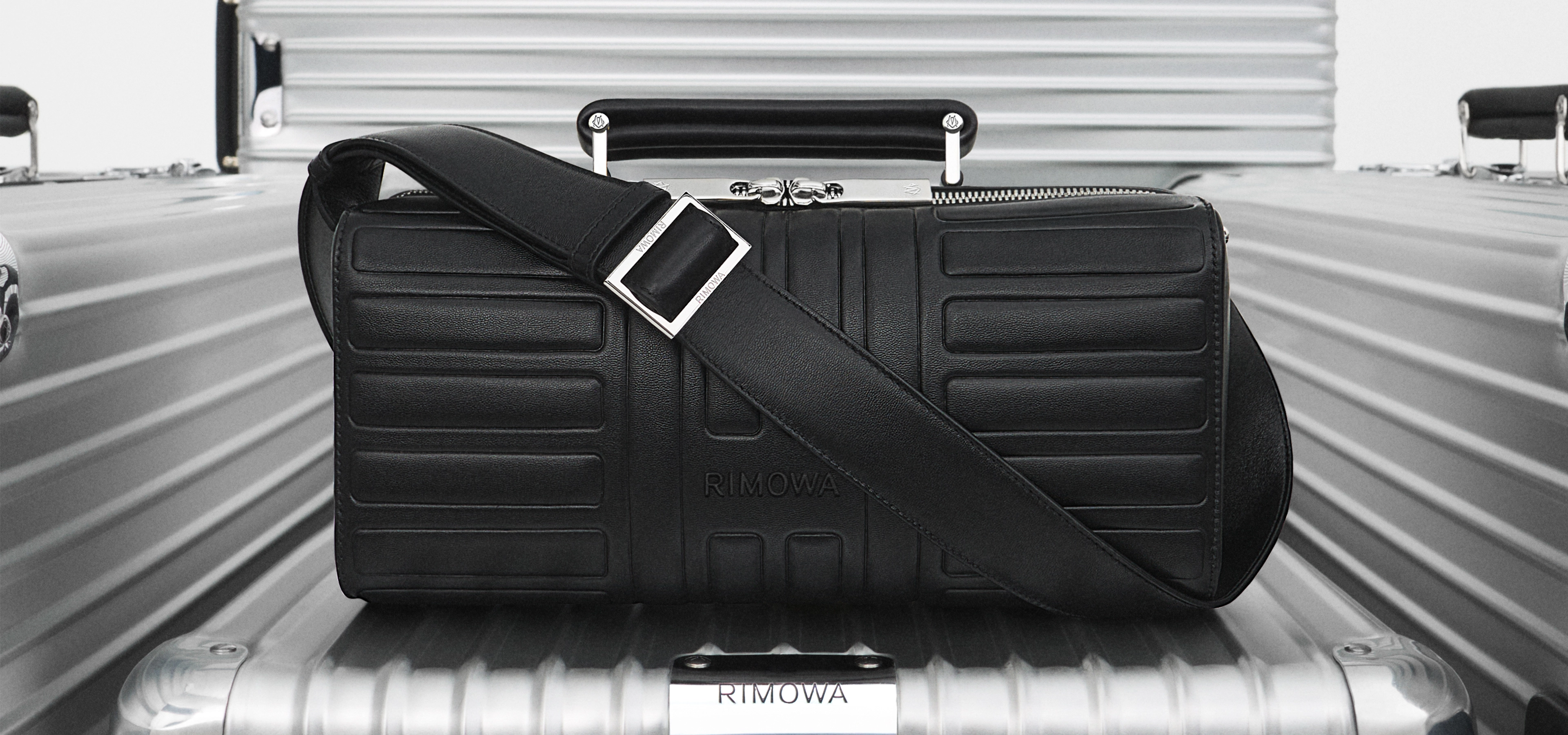 A leather holdall balanced on metal suitcases