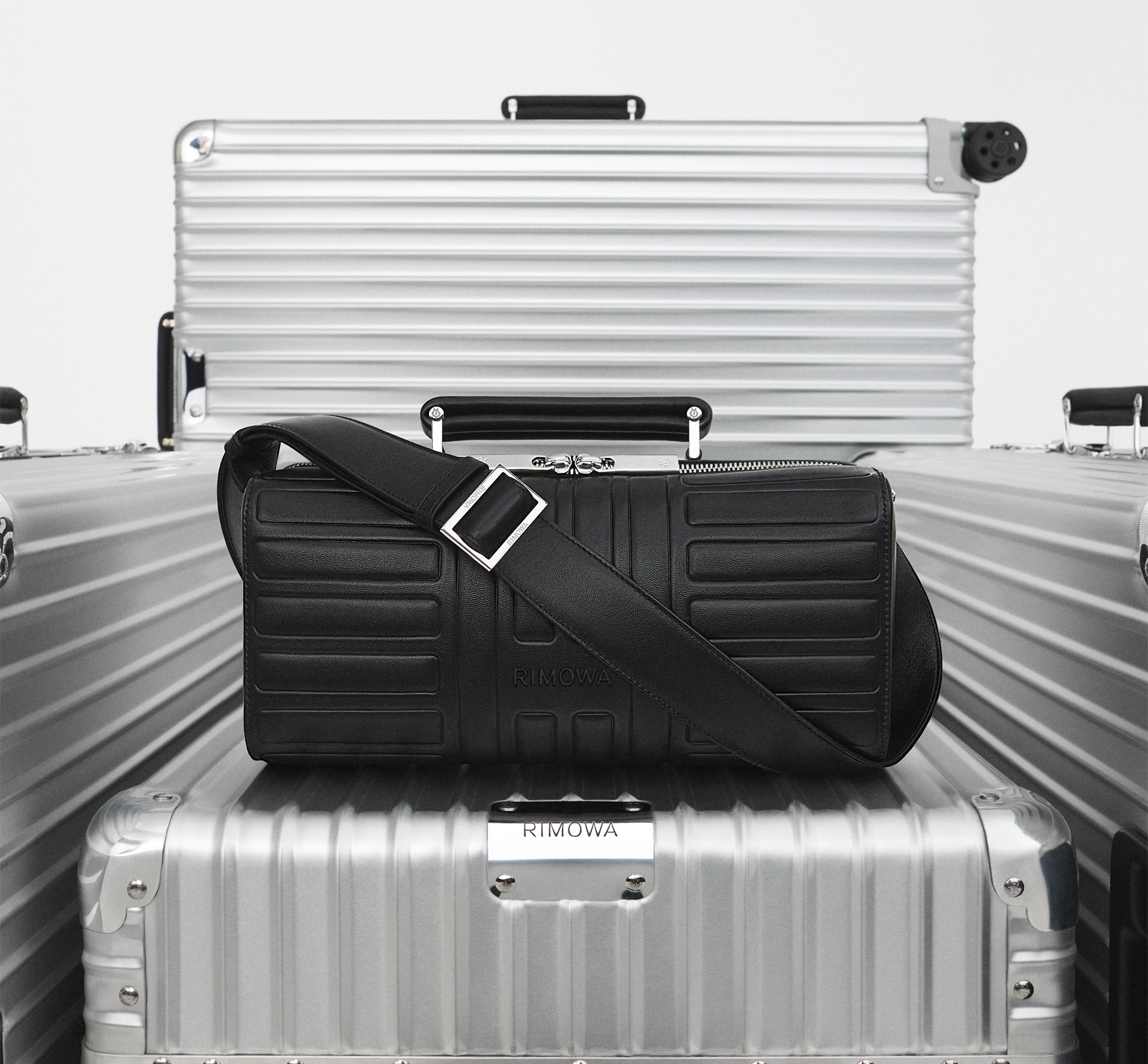 A leather holdall balanced on metal suitcases