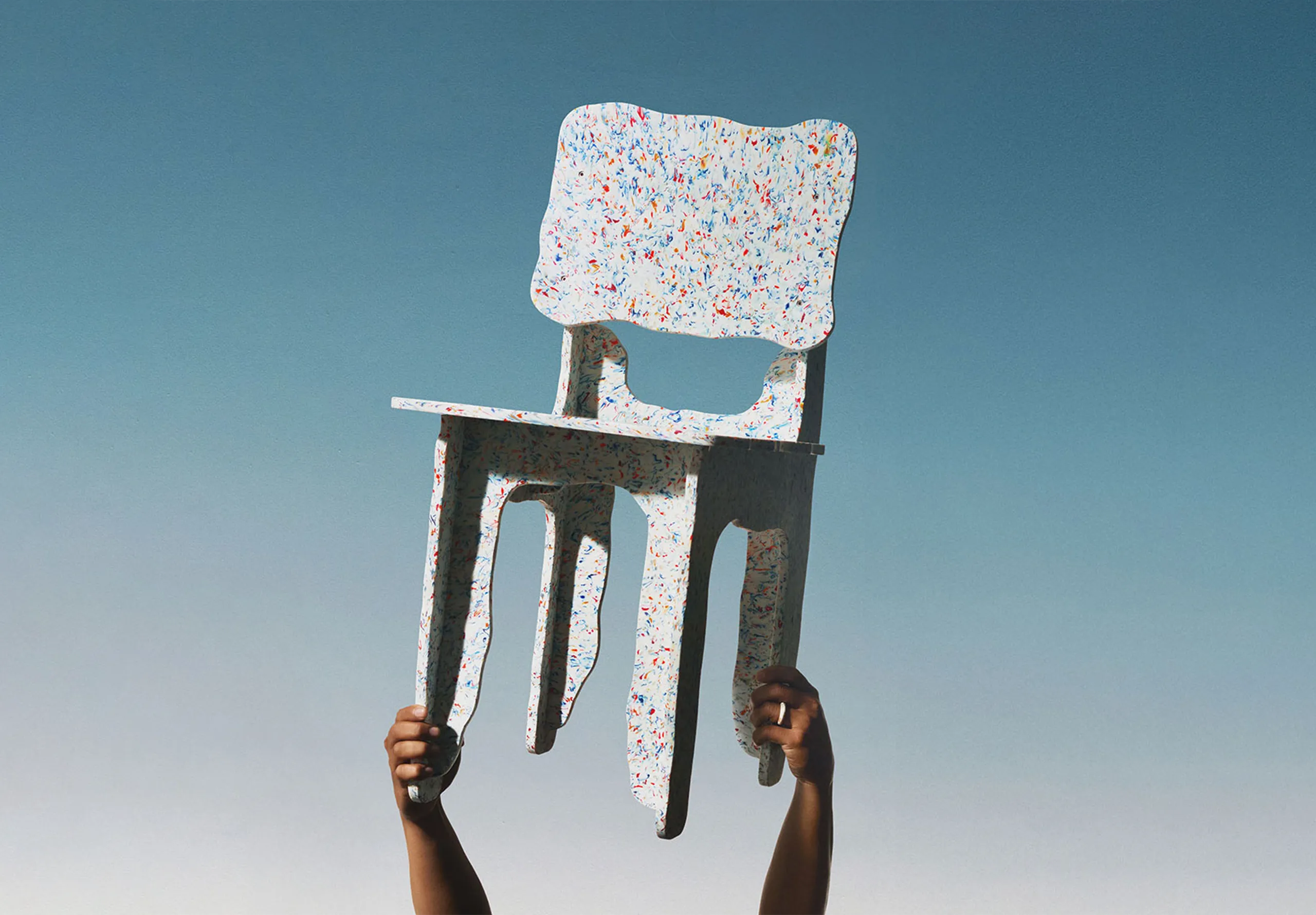 Recycled chair being held aloft