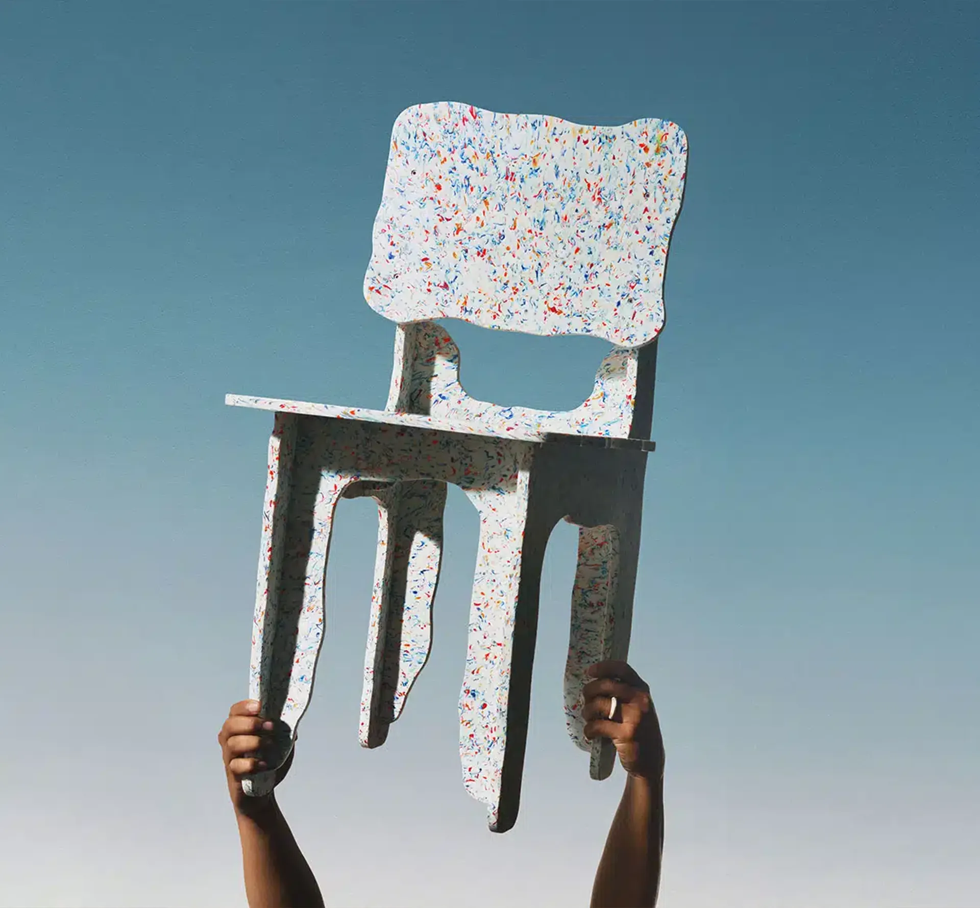 Recycled chair being held aloft
