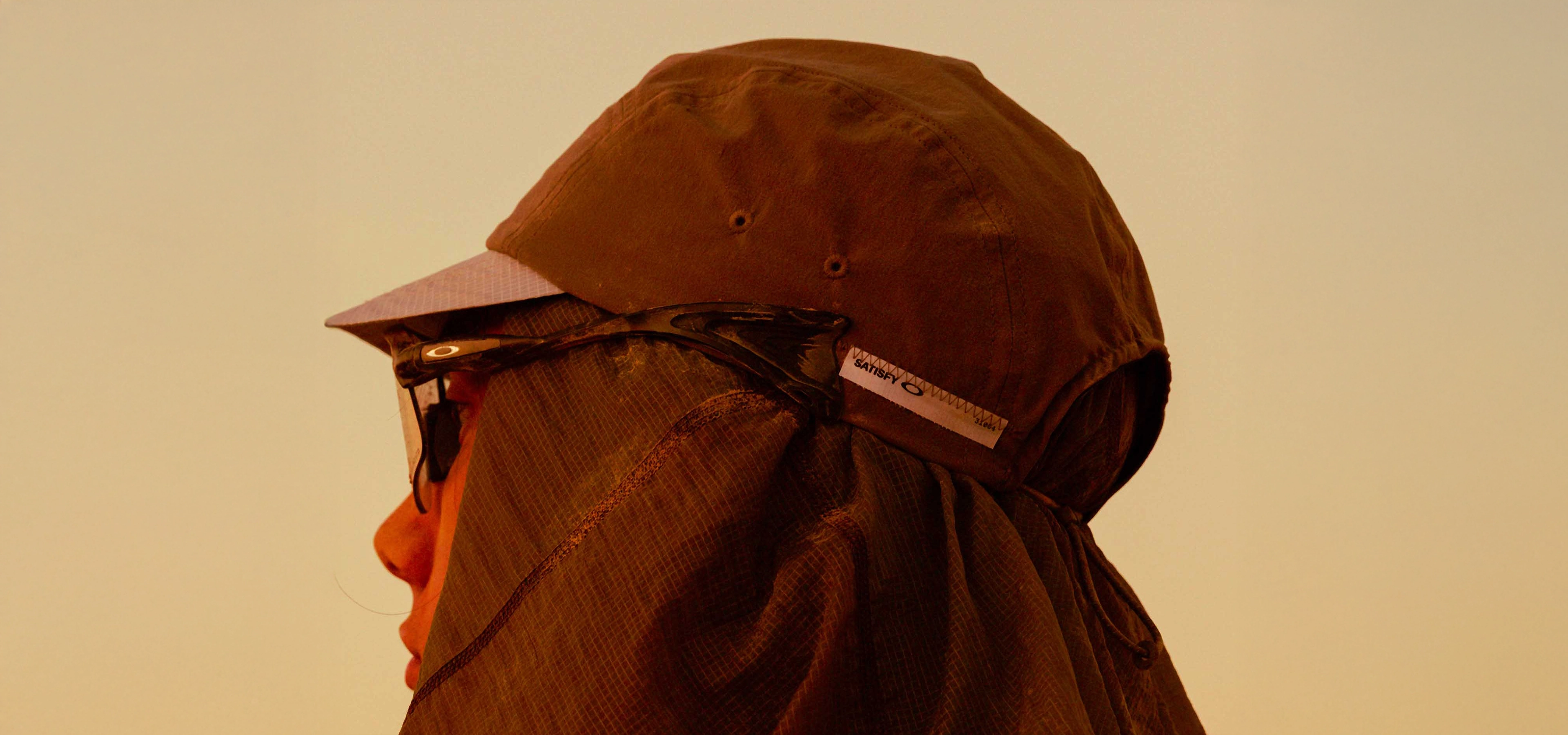 Oakley glasses on someone wearing a cap