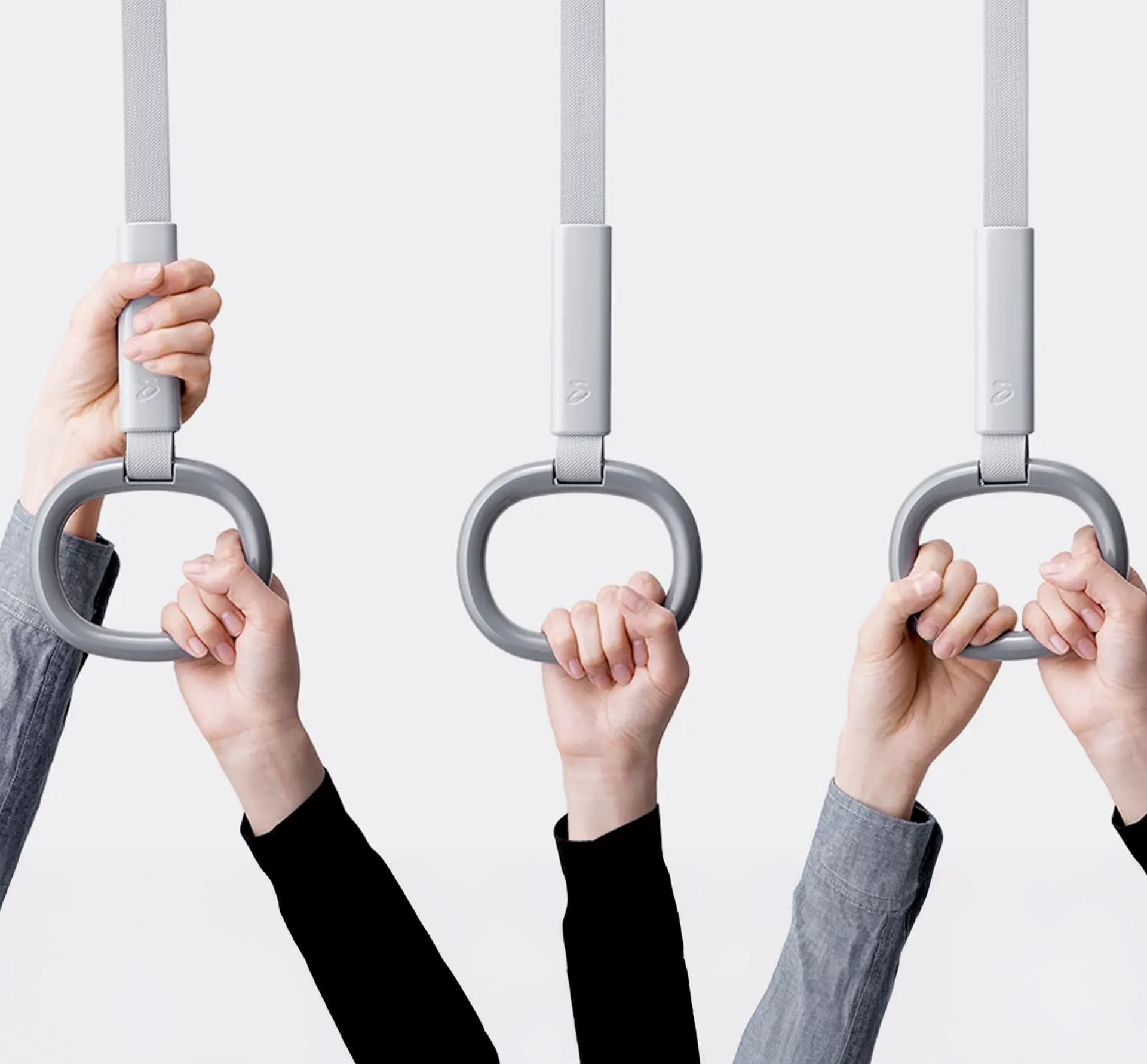 Hands holding a train handle