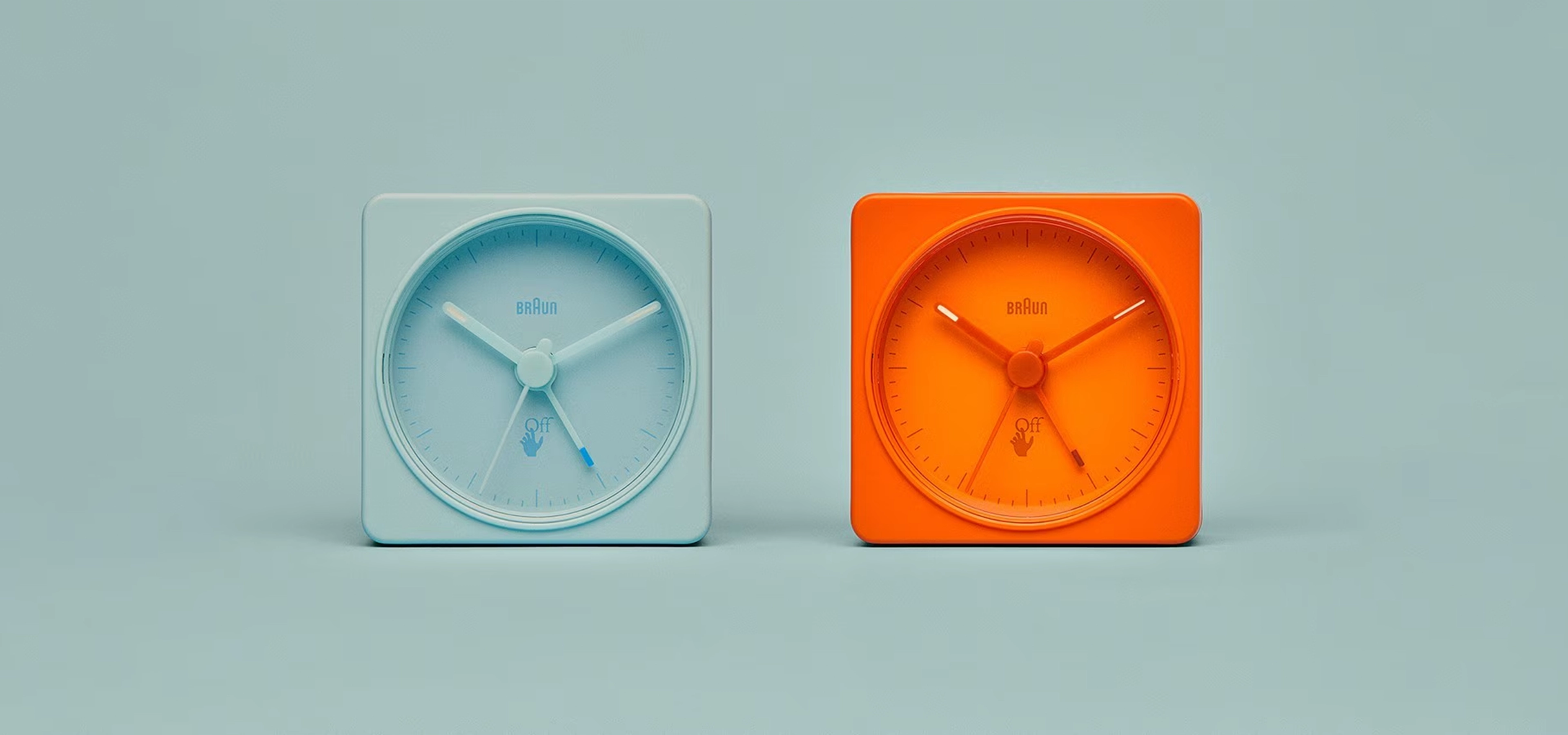 2 colourful alarm clocks on blue background