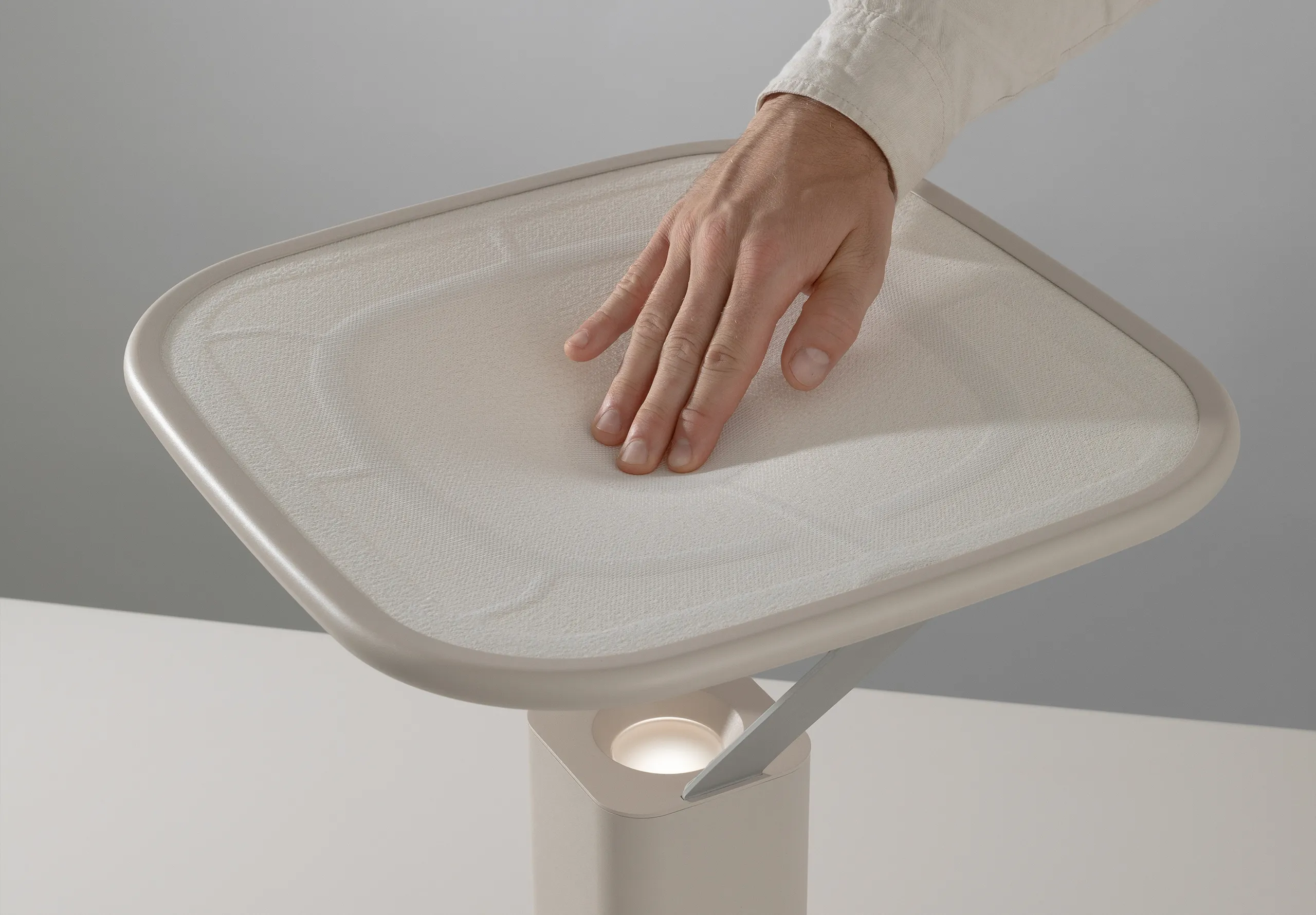 hand pressing on a fabric surface